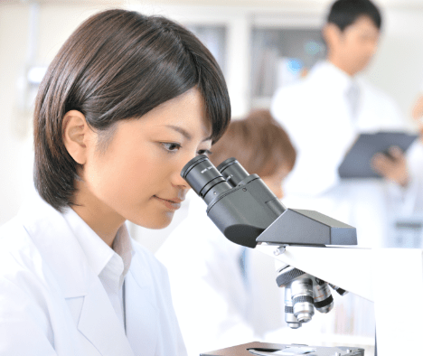 Woman looking into the microscope